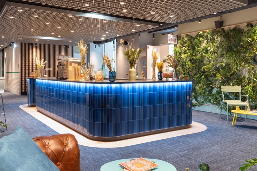 Modern reception area in Comet Bourse with blue-tiled counter for events and meetings.