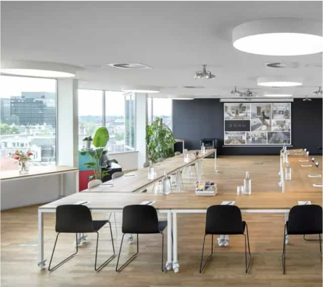 Modern meeting space at Hotel Zoku with flexible table layout for corporate events.