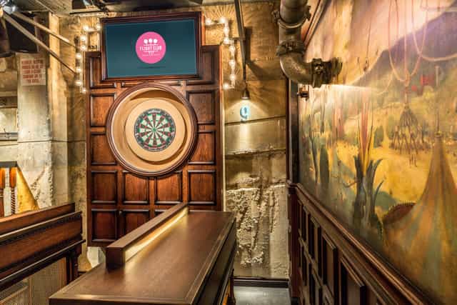 Stylish dartboard area at Flight Club Bloomsbury for team-building and social events.