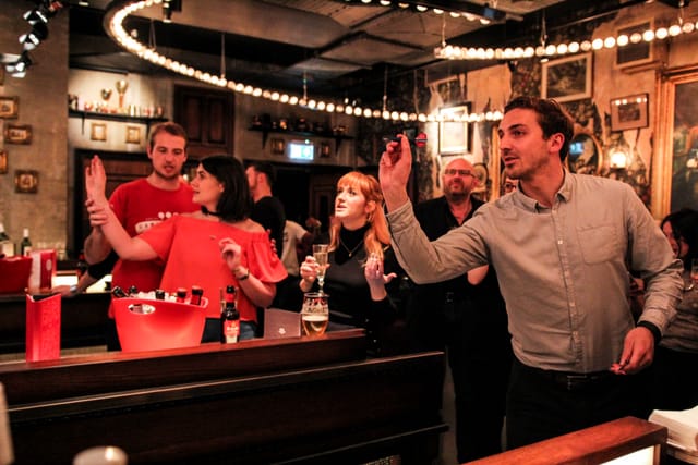 Lively social event at Flight Club Bloomsbury with warm lighting and networking opportunities.
