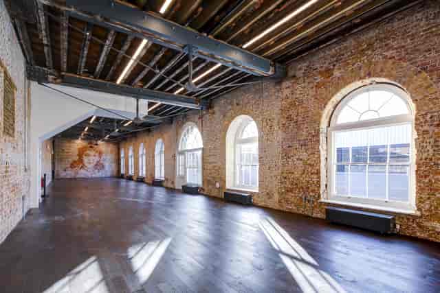 Spacious Knight Gallery venue with exposed brick, perfect for corporate events and workshops.