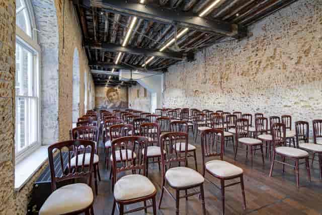 Spacious Knight Gallery venue with wooden chairs, perfect for workshops and seminars.