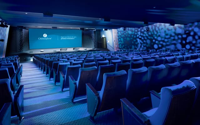 Modern auditorium with tiered seating, ideal for conferences and corporate events.