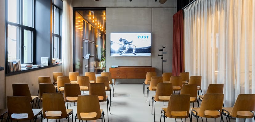 Modern meeting space in YUST with rows of chairs for corporate events and workshops.