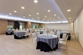 Event space at Melia Avenida de America with round tables for conferences and workshops.