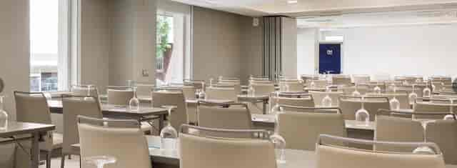 Meeting room at NH Zurbano, featuring clean lines and natural light for conferences.