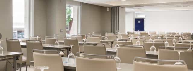 Meeting room at NH Zurbano, featuring clean lines and natural light for conferences.