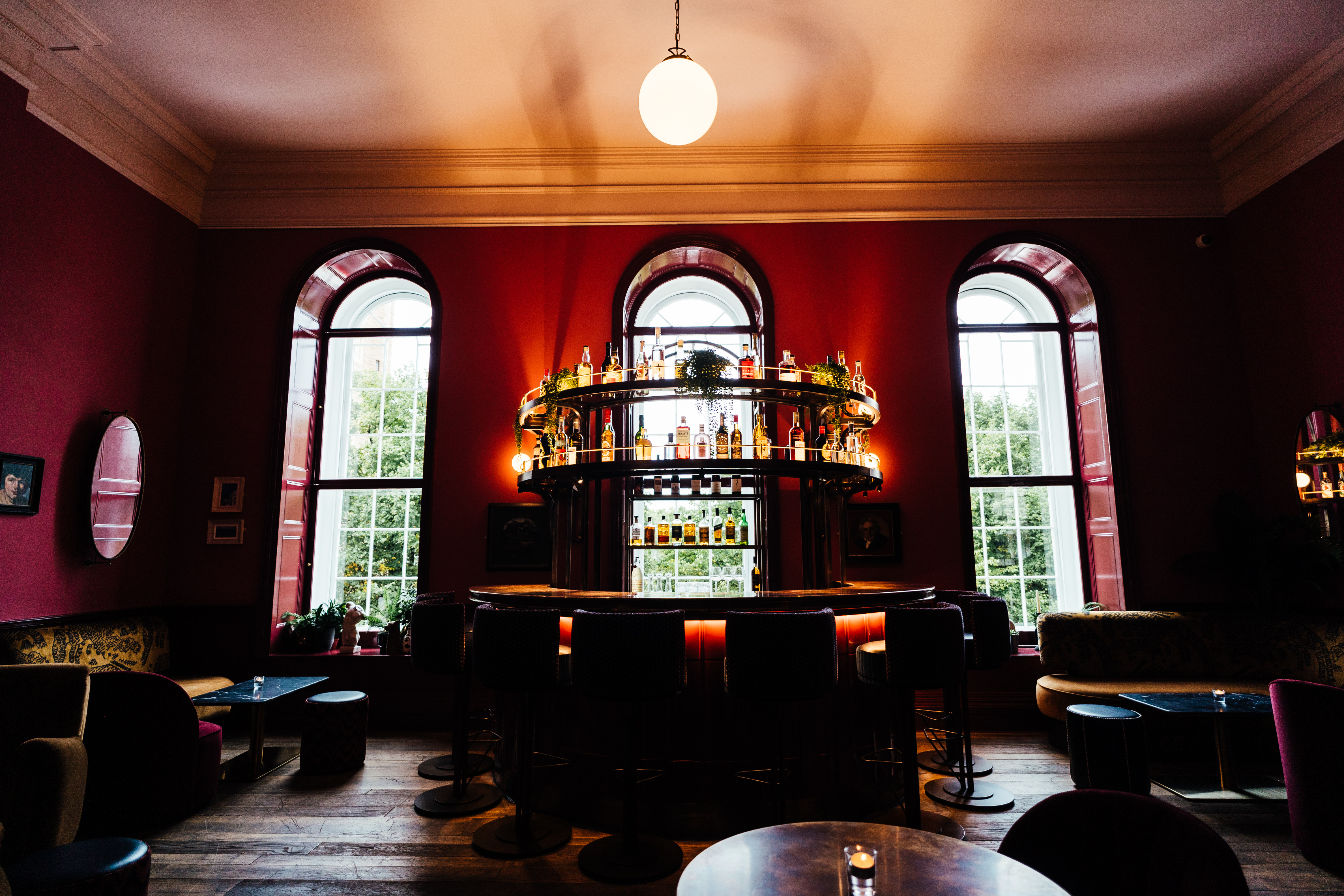 Intimate bar in Kindred with red walls, ideal for networking and social events.