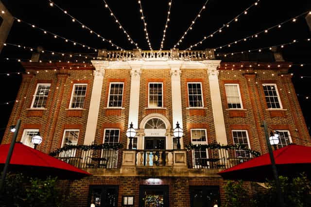 Elegant evening event venue with warm string lights and outdoor seating.
