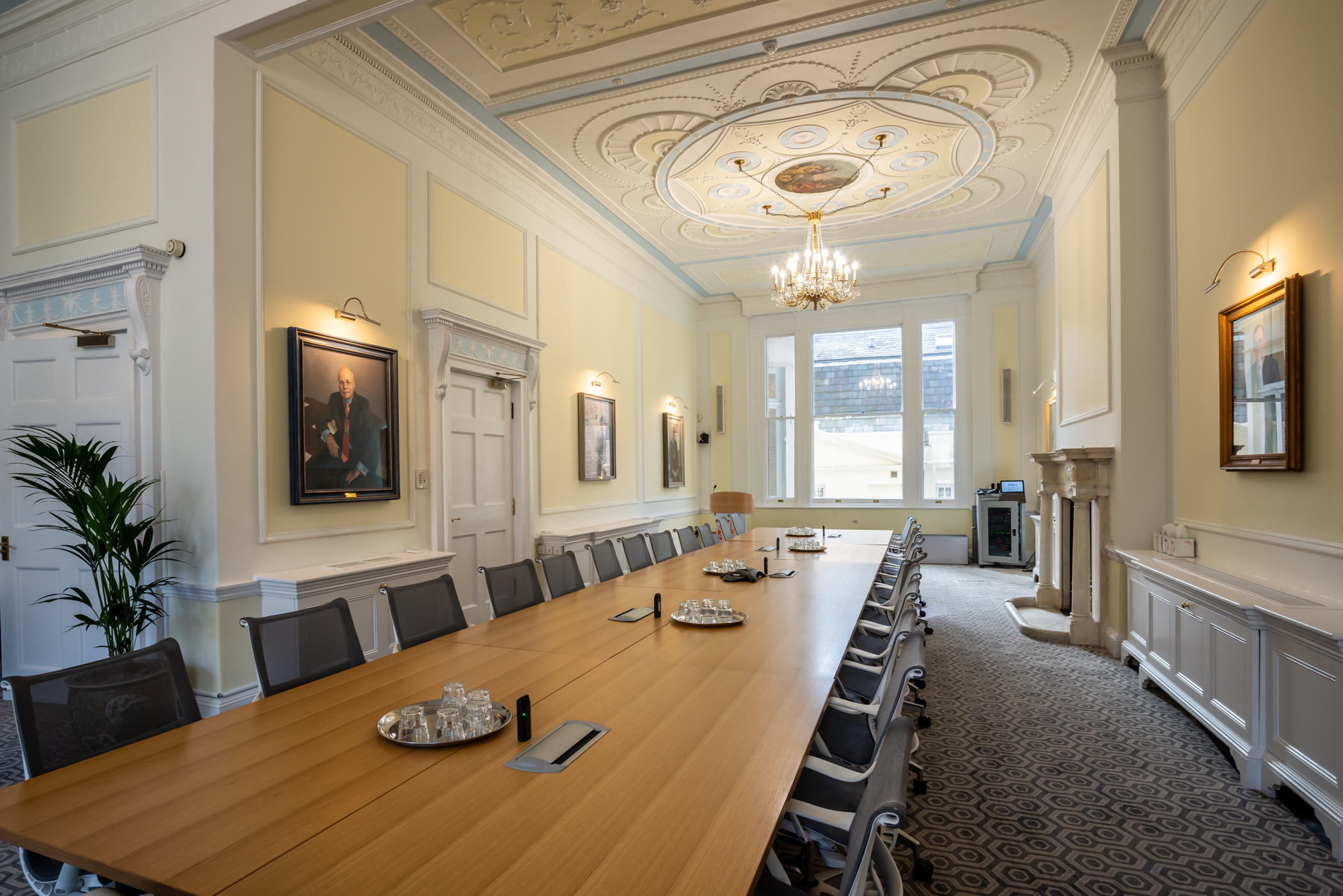 Sophisticated meeting room with wooden table at Intavent Suite, ideal for board meetings. - Banner