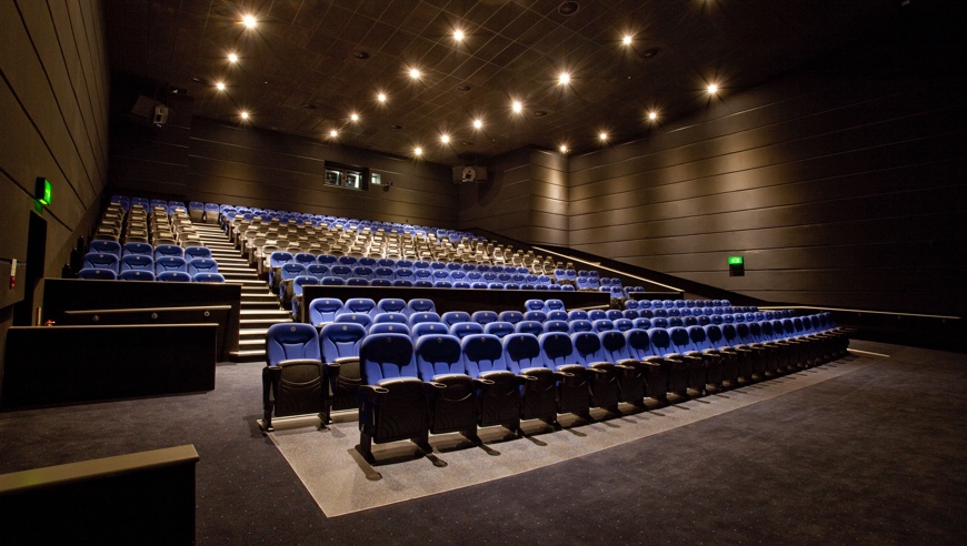Modern auditorium with tiered seating for conferences and screenings at ODEON Trafford Centre. - Banner