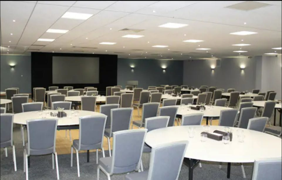 Fair Isle meeting space with round tables, ideal for conferences and events.