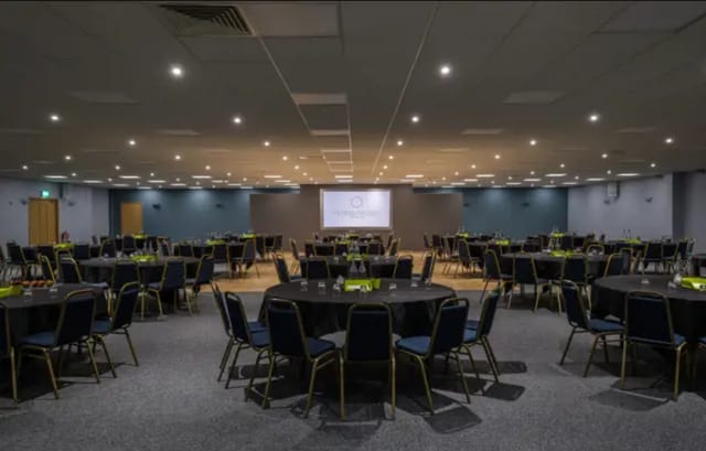 Fair Isle event space with round tables, ideal for corporate banquets and conferences.