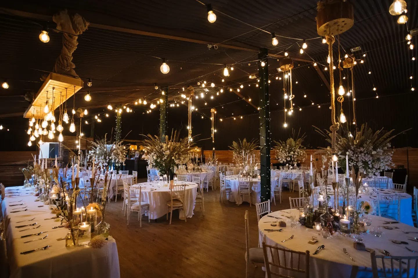 Stock Farm Barn wedding venue with elegant decor and warm ambient lighting.