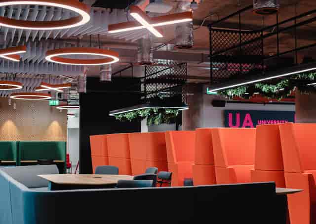 Modern meeting space at UA92 Manchester, featuring bold colors for creative collaboration.