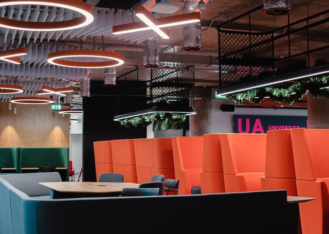 Modern meeting space at UA92 Manchester, featuring bold colors for creative collaboration.