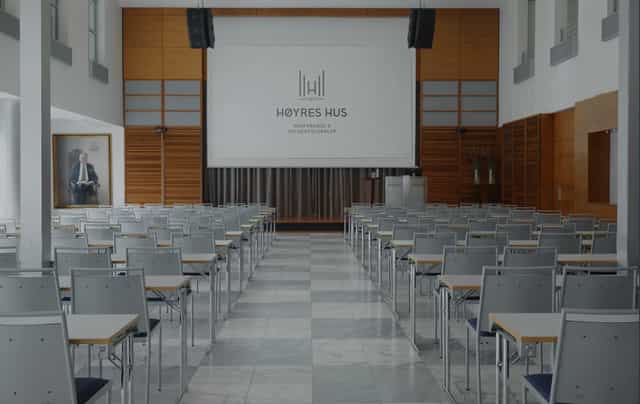 Conference room at Nordengen, featuring a large screen for professional meetings and events.