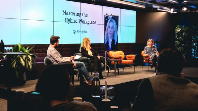 Panel discussion on "Mastering the Hybrid Workplace" in modern Disruption Hall, Stockholm.