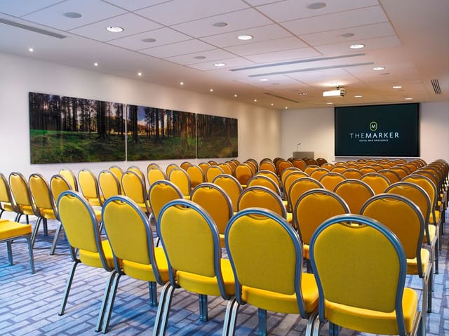 The Marker Suite with yellow chairs, perfect for professional meetings and workshops.