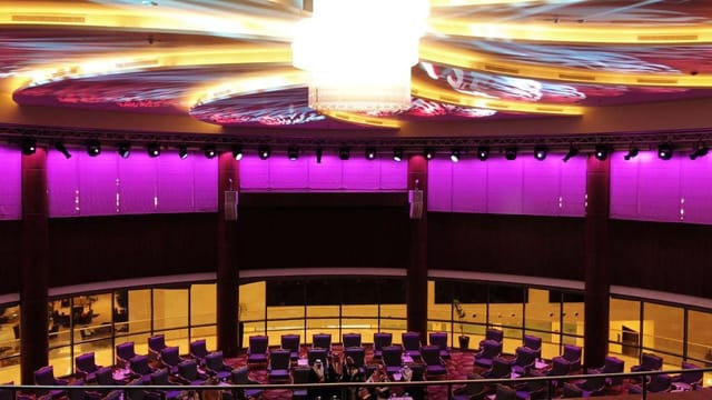 Modern event space at Crowne Plaza Riyadh with circular layout and vibrant lighting.