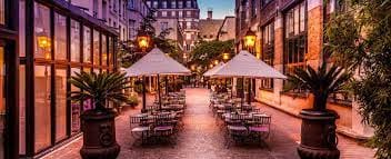 Charming outdoor event venue in Monaco with elegant tables and lush greenery.