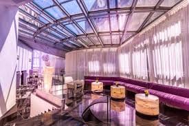 Modern event space in Monaco with glass ceiling, ideal for corporate meetings and gatherings.