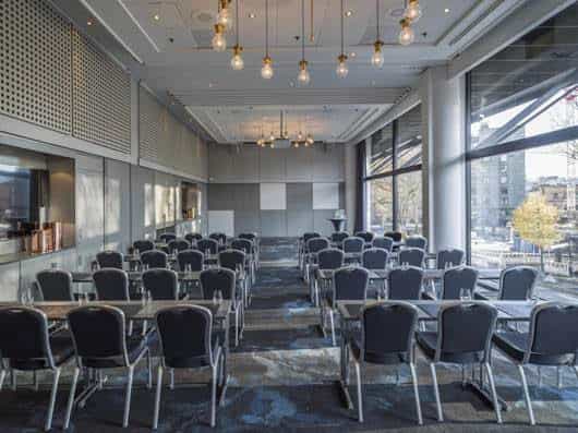 Versatile meeting room with natural light for corporate events in Radisson Blu Oslo.