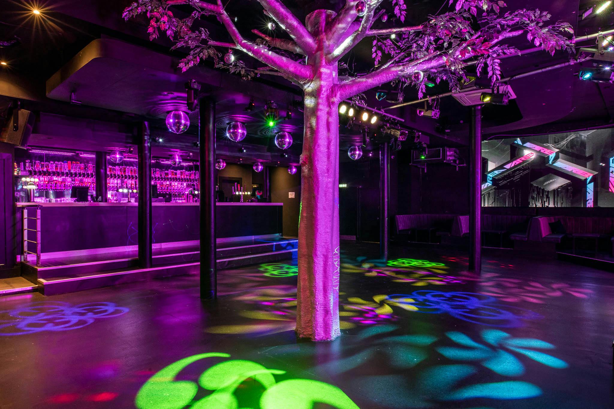 Vibrant Manchester event space with illuminated tree, perfect for parties and networking.