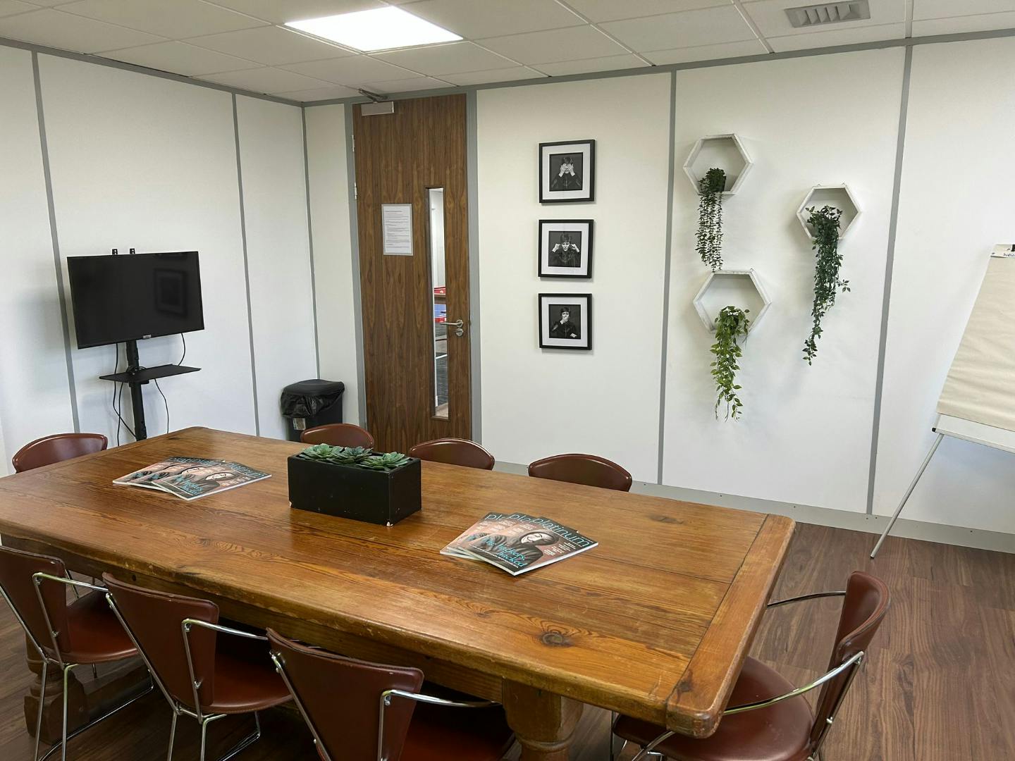 Meeting room with wooden table and plants at Freedom Works, Crawley for collaborative events.