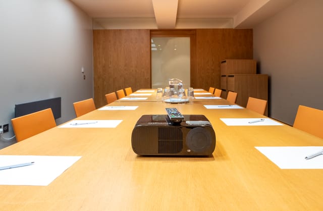 Modern conference room in Harrogate with orange chairs, ideal for professional meetings.
