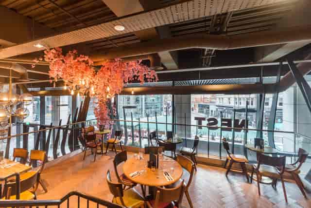 Modern dining venue at Nest Bishopsgate with floral decor, ideal for events and gatherings.