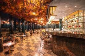 Stylish bar at Florattica London with autumn decor, ideal for networking events.