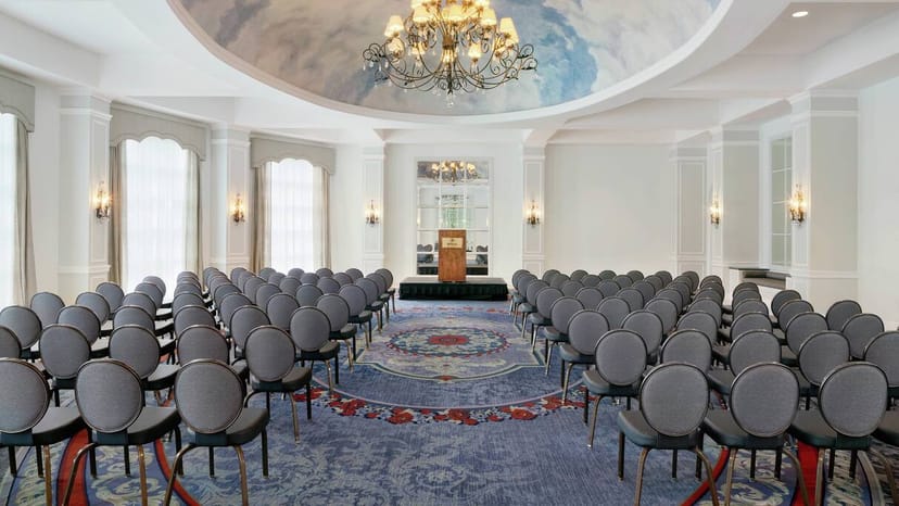 Elegant Hilton Pearl River meeting room with chandelier, perfect for conferences and presentations.