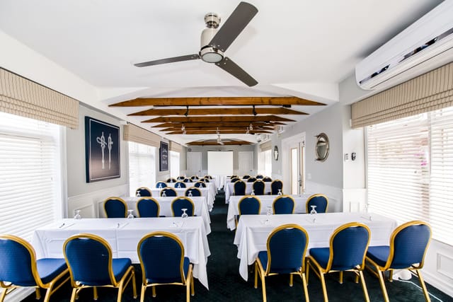 Professional meeting room in Brookhaven, featuring elegant blue chairs and natural light.