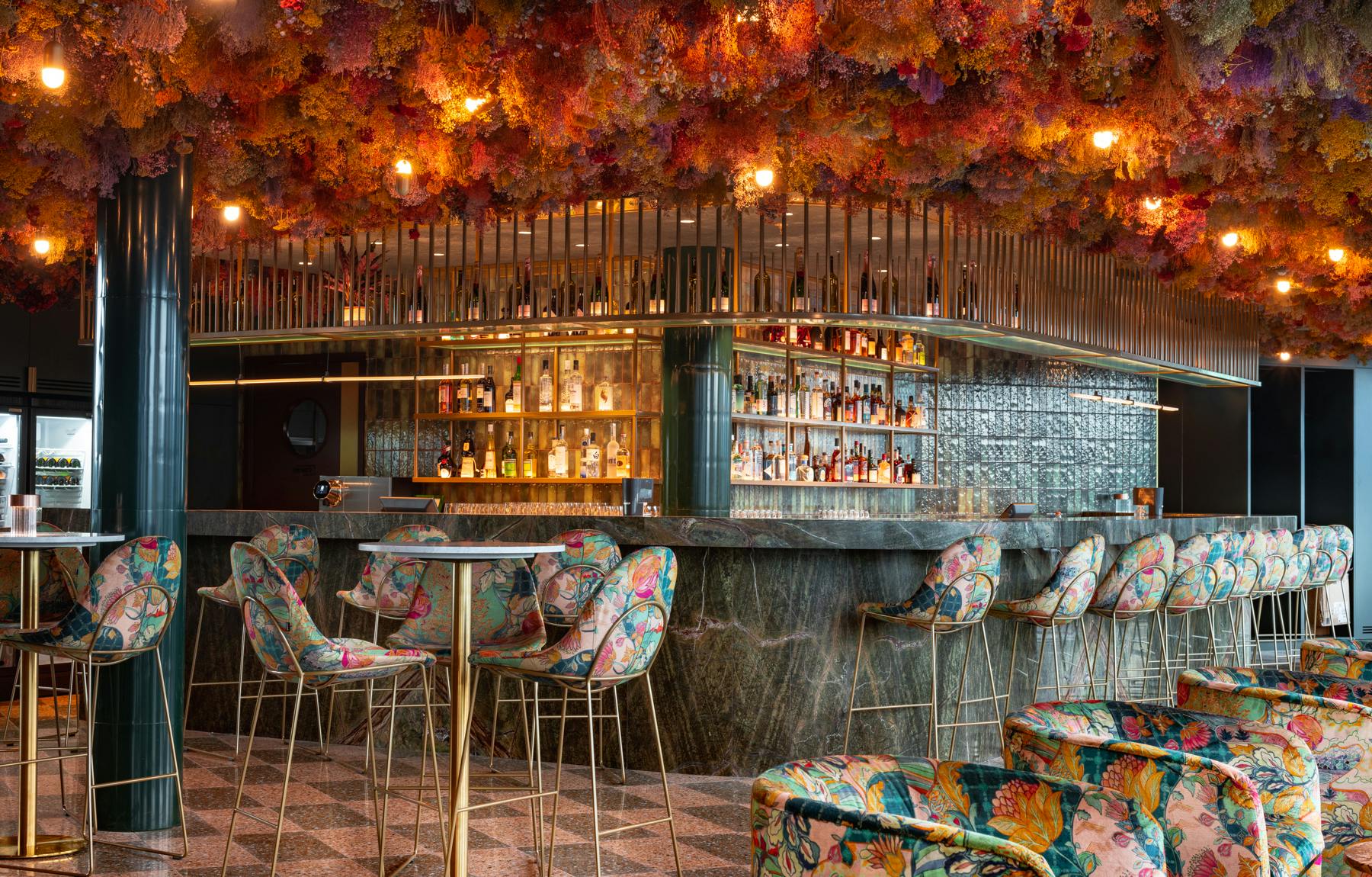 Vibrant bar area with floral ceiling, ideal for networking events and cocktail receptions.