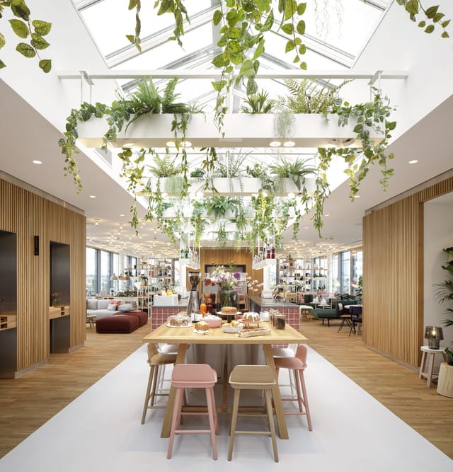 Modern event space with lush greenery, ideal for networking and gatherings.