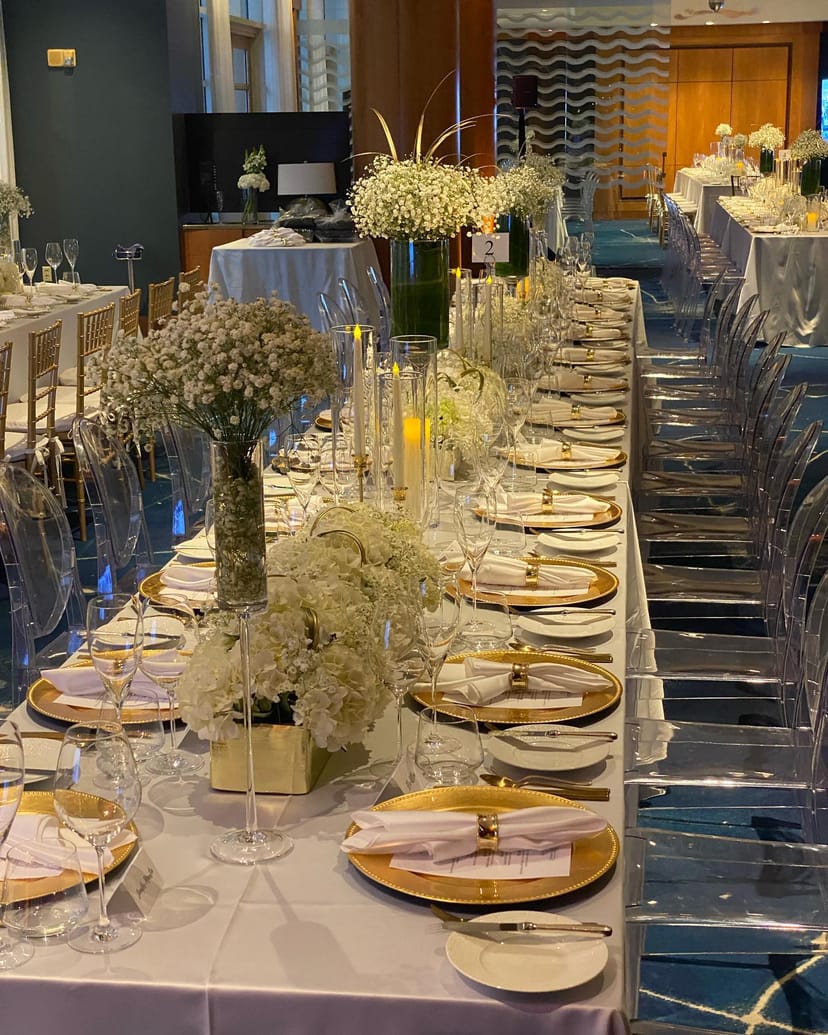 Elegant banquet table with white flowers for weddings and corporate events.