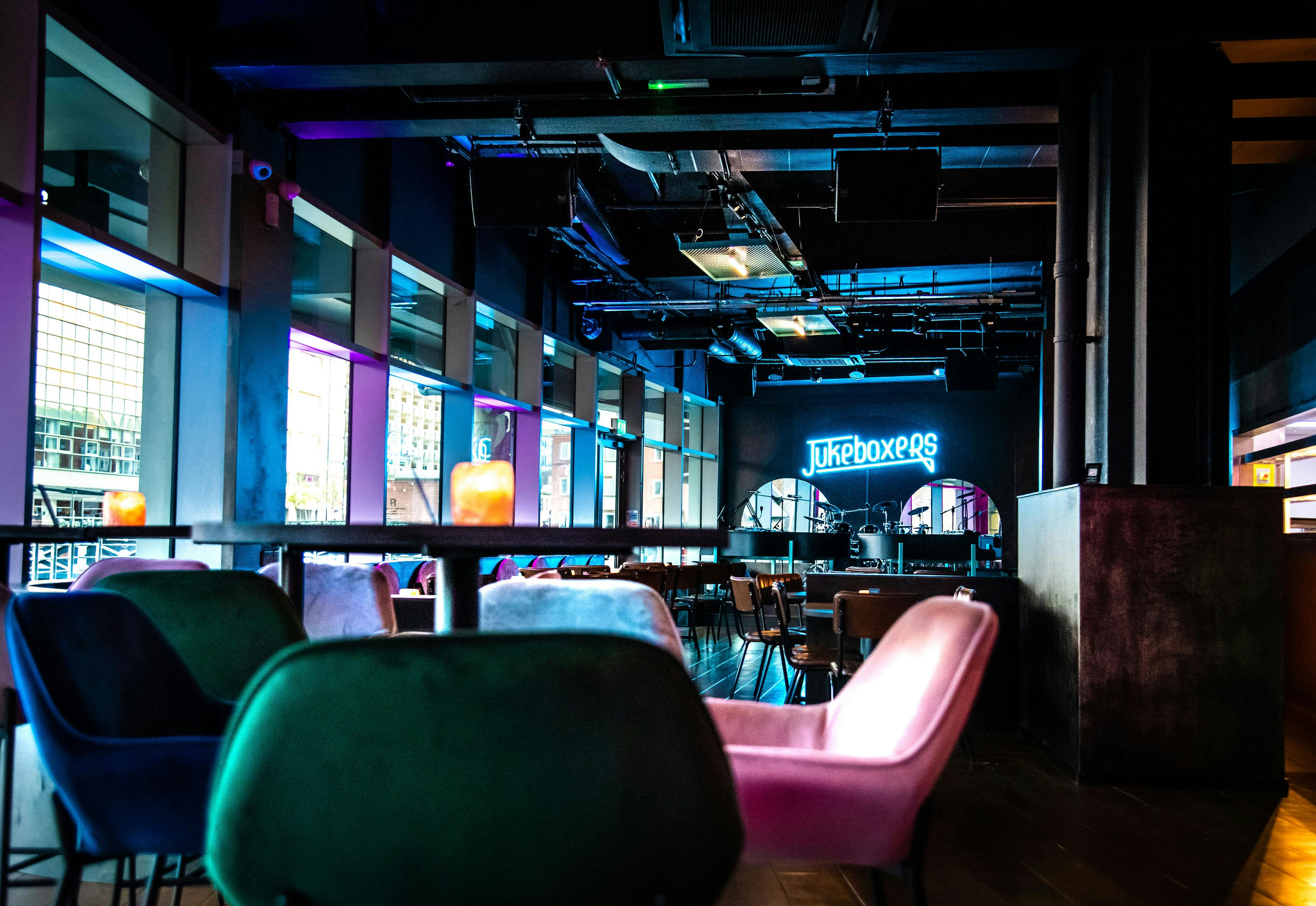 Modern event space with vibrant lighting at Jukeboxers Duelling Piano Bar for gatherings.