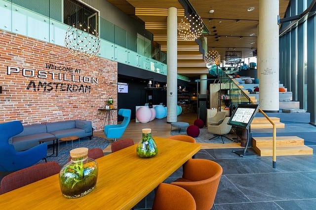 Modern lobby at Postillion Hotels Amsterdam, featuring stylish seating for events and meetings.
