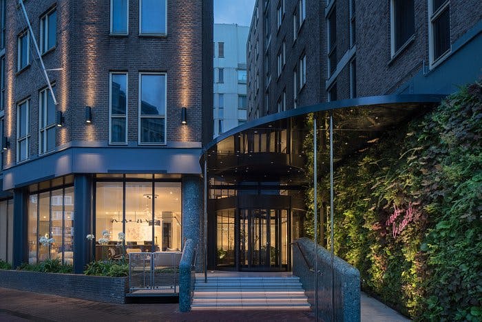 Modern hotel entrance at Kimpton De Witt, ideal for corporate events and social gatherings.