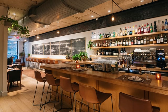 Private dining room with sleek bar, ideal for intimate gatherings and networking events.