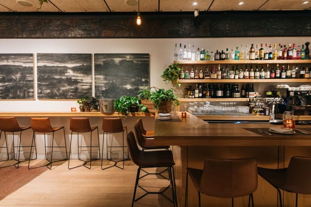 Private dining room bar with modern decor, ideal for networking events and gatherings.