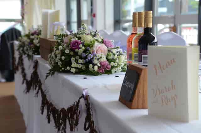 Elegant event table with floral centerpiece at Royal Welsh Showground for weddings.