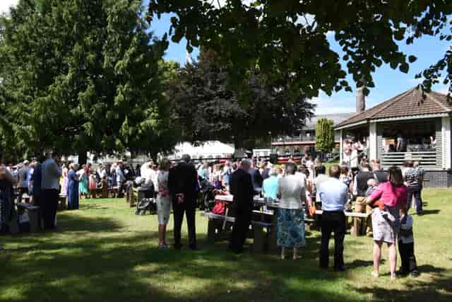 Outdoor corporate event at The Bandstand, featuring a gazebo and networking attendees.