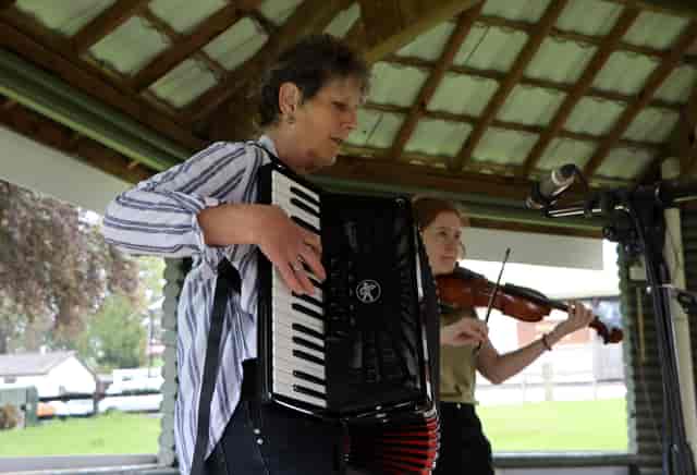 Outdoor performance at Royal Welsh Showground with accordion and violin musicians.