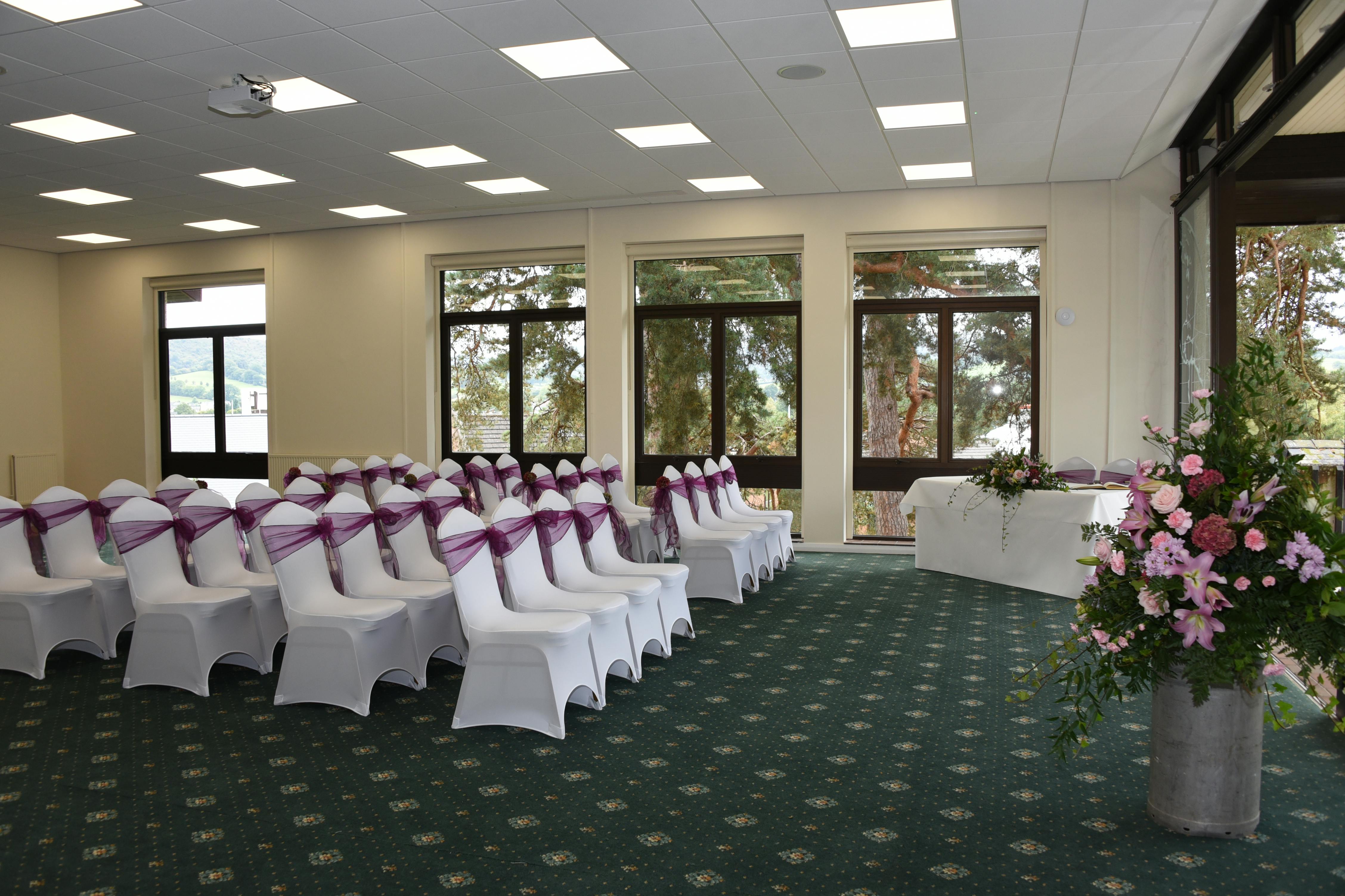 International Pavilion at Royal Welsh Showground, elegant wedding venue with purple sashes.