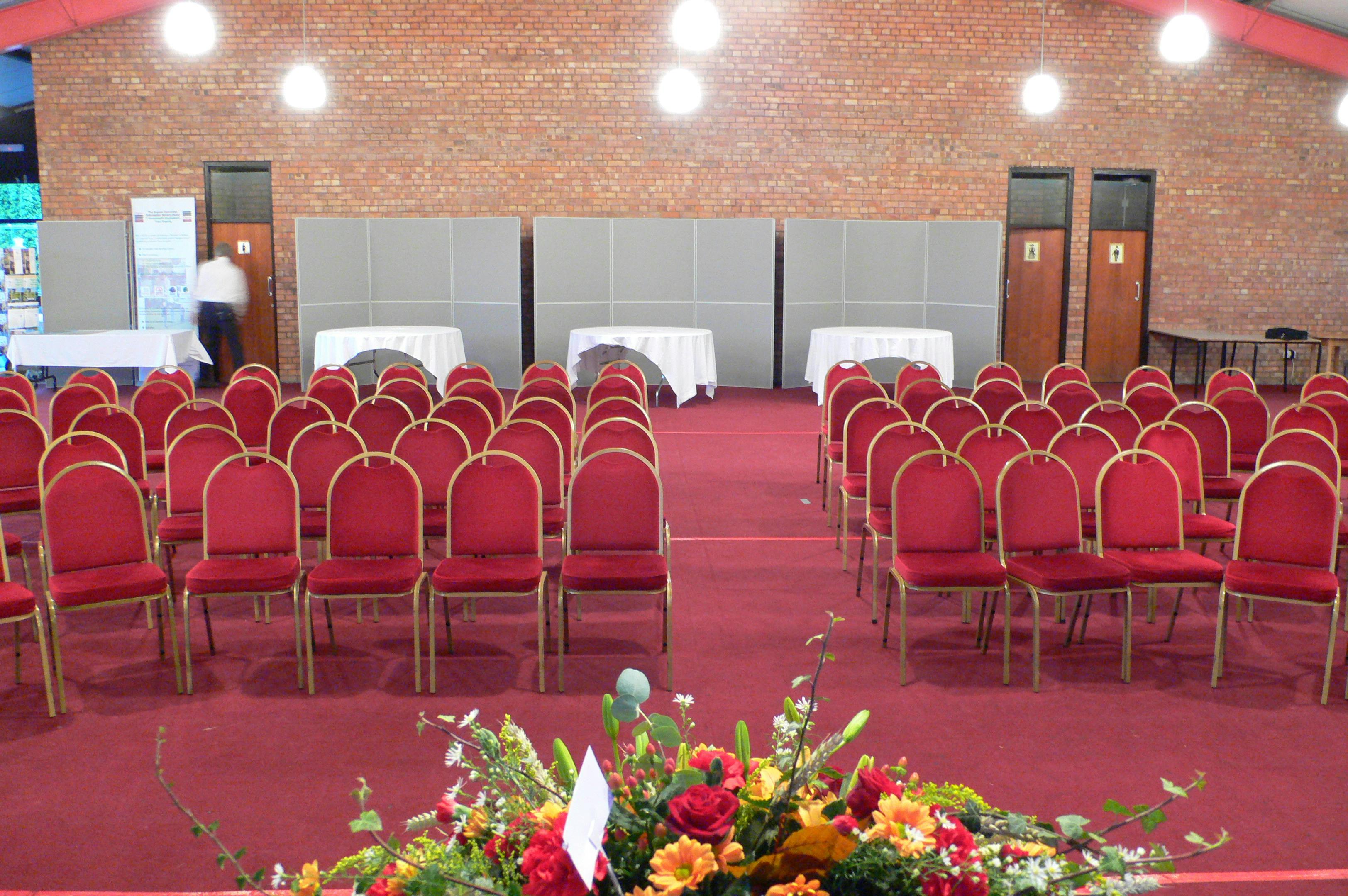 Montgomeryshire Pavilion with red chairs, ideal for conferences and seminars.