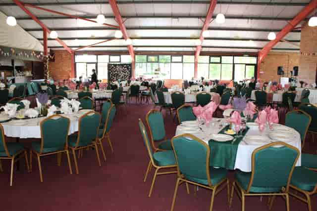 Montgomeryshire Pavilion set for a wedding with elegant white and pink table settings.