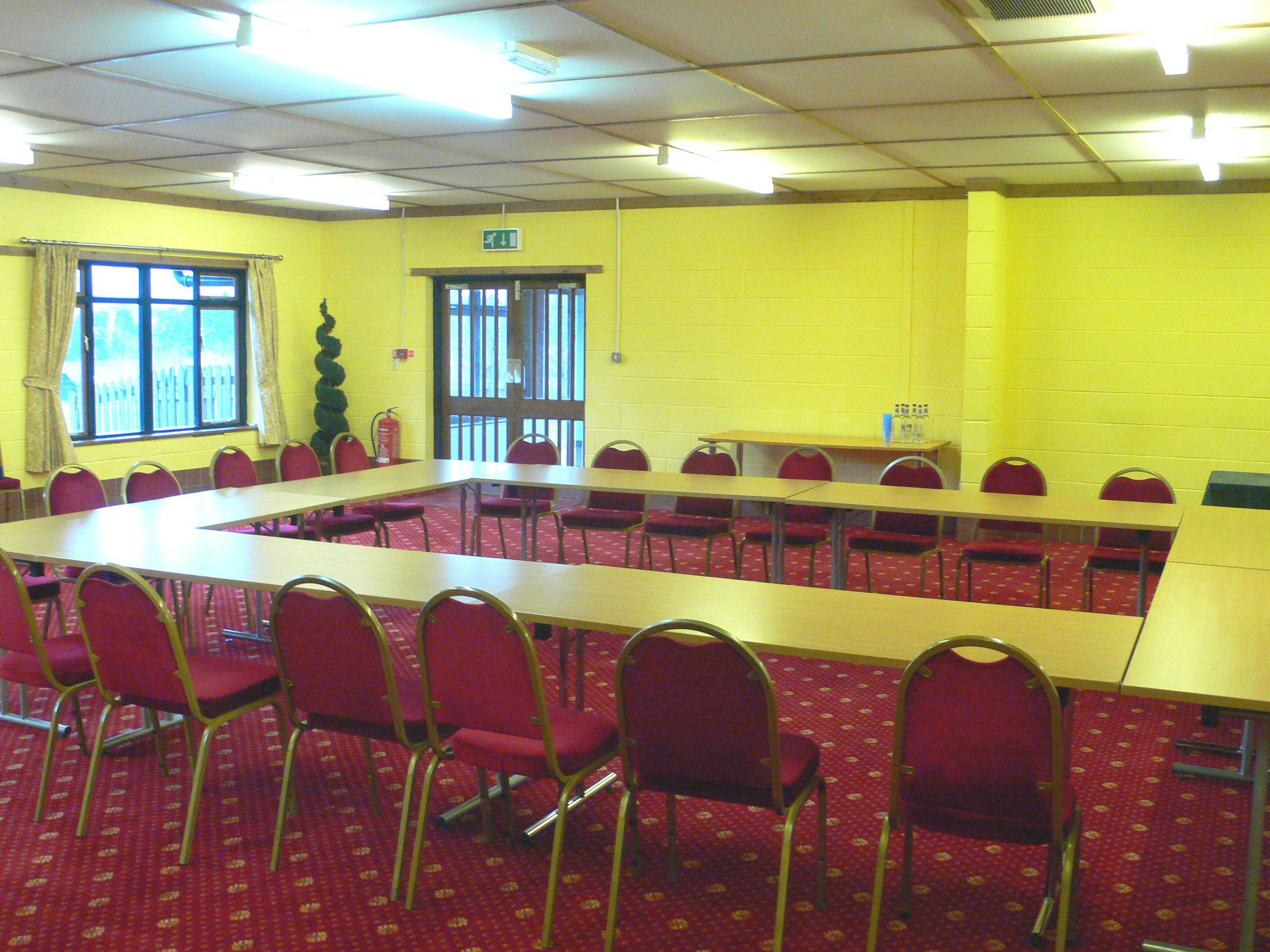 Hafod a Hendre meeting space with U-shaped tables, ideal for workshops and team meetings.