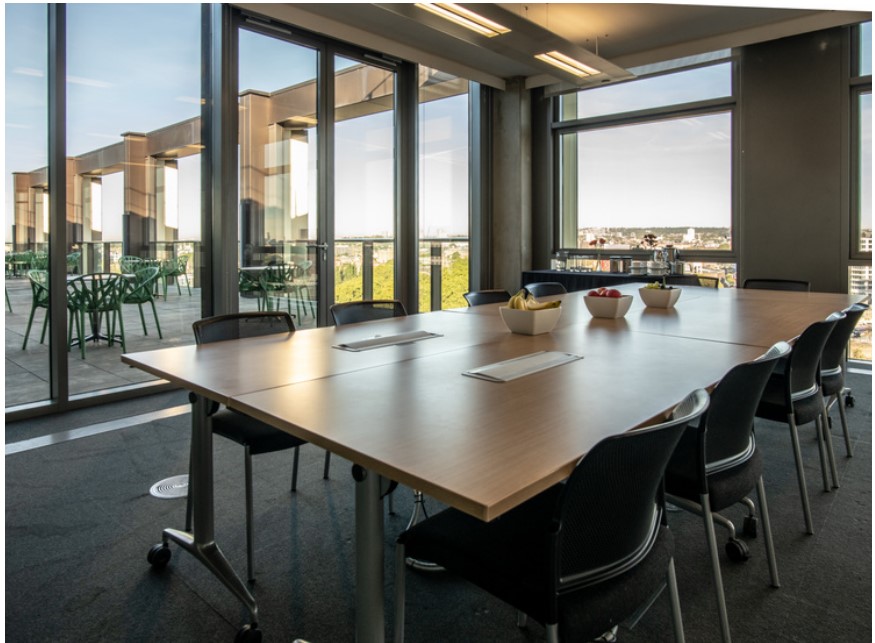 Modern meeting room with large windows at 5 Pancras Square, ideal for events and collaboration. - Banner